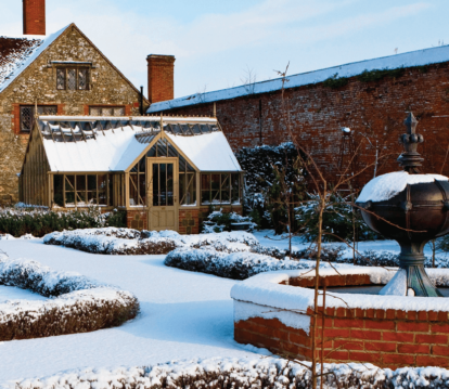 Alitex Greenhouse sitting upon frosty snowy walled garden