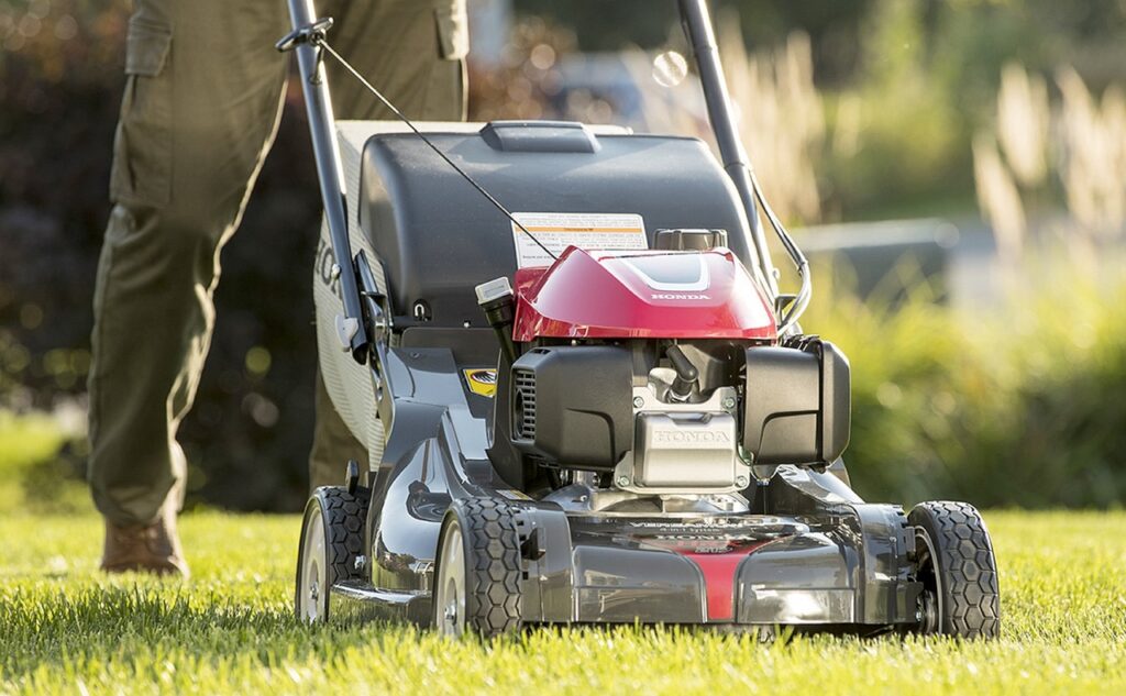 What garden tools do I need? A man mowing his lawn