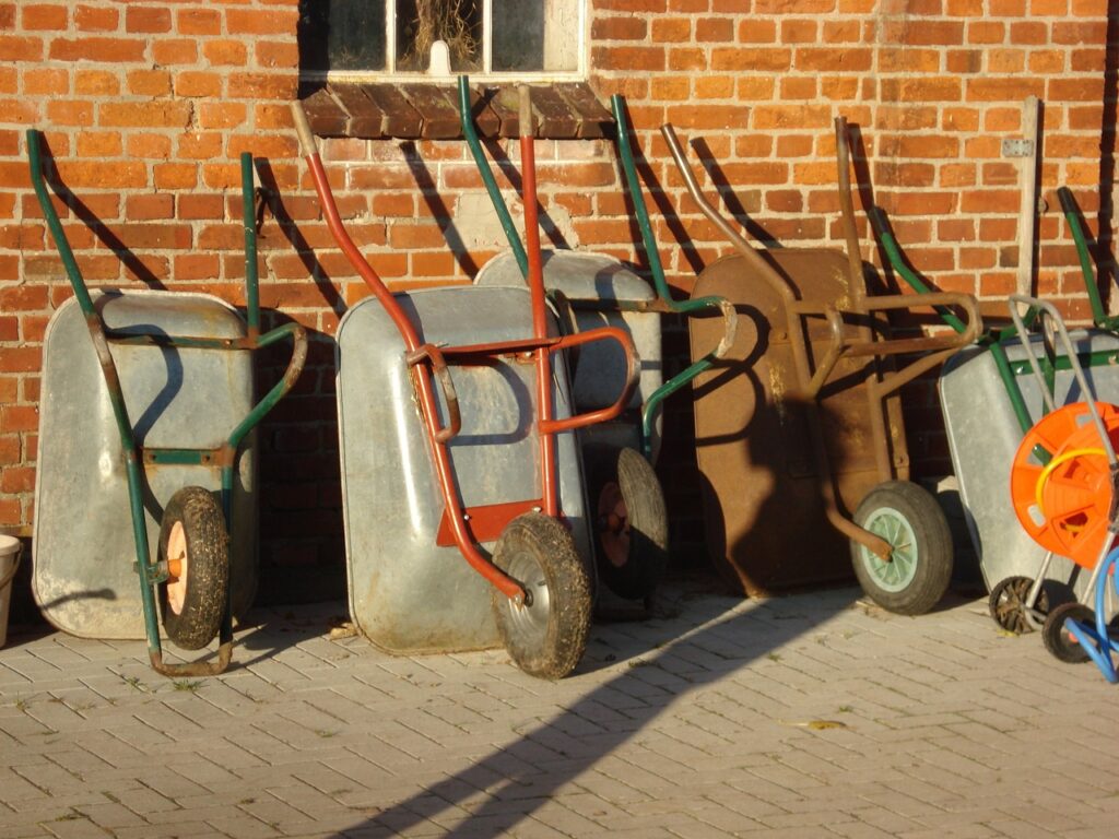 What garden tools do I need? Wheelbarrows line up against a wall