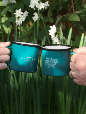 a photo of two people cheersing an alitex greenhouse mug