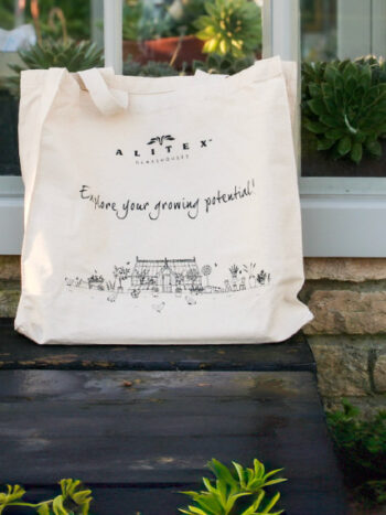 alitex tote bag in front of an alitex greenhouse